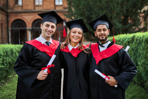 portrait-three-smiling-graduate-friends-graduation-robes-university-campus-with-diploma